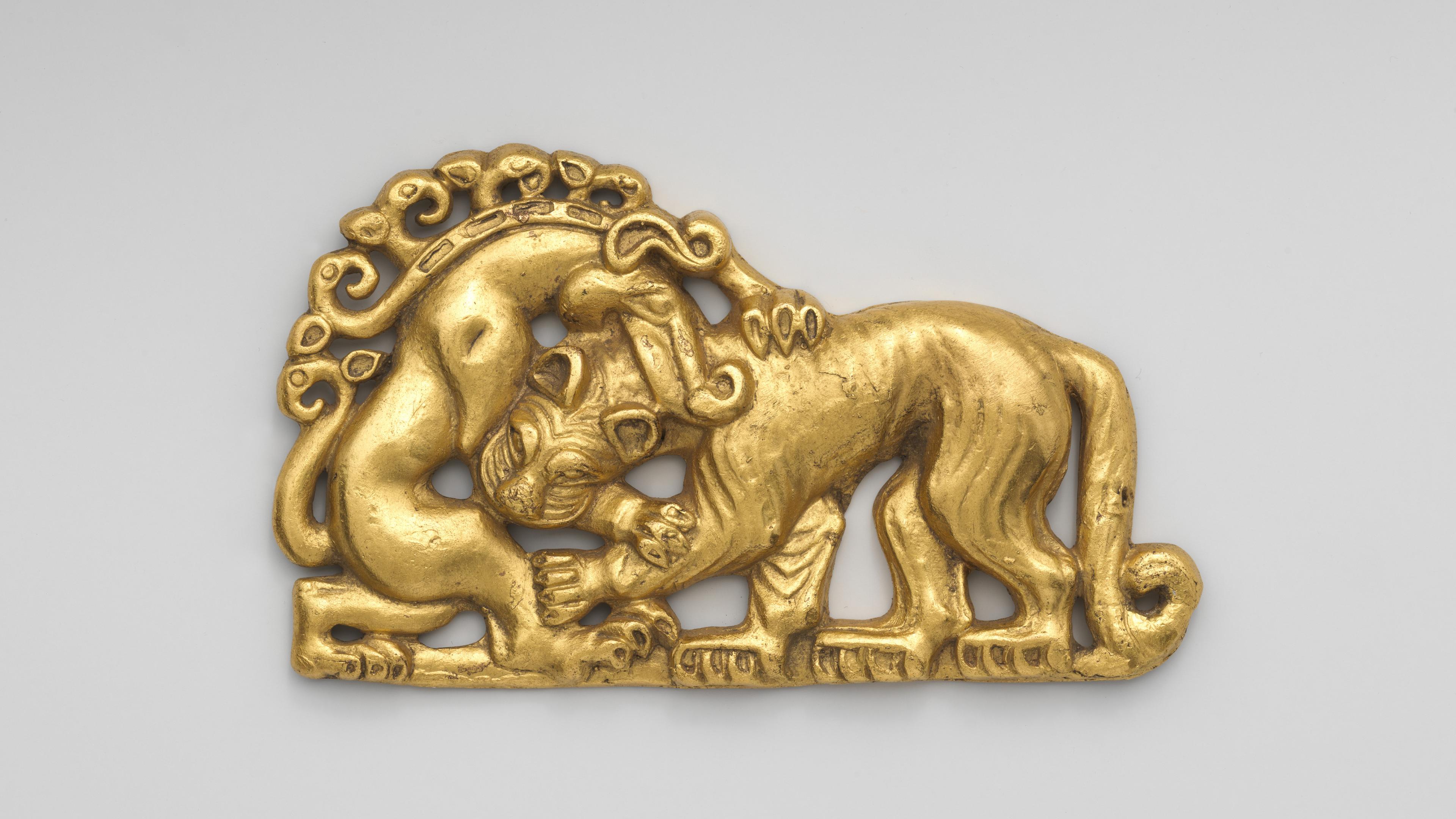 Gold plaque depicting a combat between a tiger and a horned monster