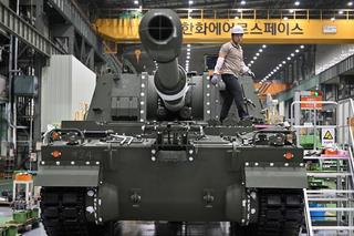 A South Korean engineer works on a K-9 self propelled howitzer at Hanwha Aerospace factory in Changwon, September 2023.