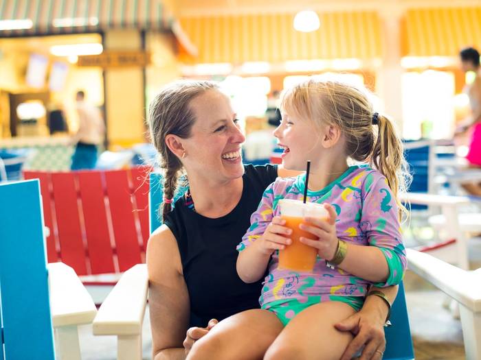 Mother and daughter looking at each other and smiling while at Avalanche Bay Waterpark.
