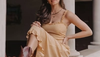 Woman wearing yellow sundress and brown booties