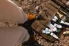 paint supplies laying on desert ground