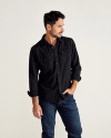 Man wearing black denim pearl snap long sleeve button down