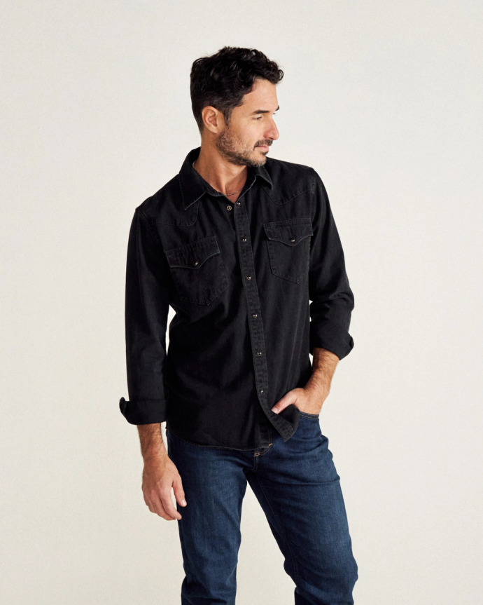 Man wearing black denim pearl snap long sleeve button down