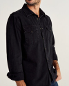 Man wearing black denim pearl snap long sleeve button down