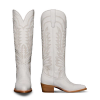 Two white cowboy boots with intricate stitching patterns, wooden heels, and pointed toes. One boot is shown from the back and the other from the side.
