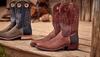 Two pairs of Tecovas Parker boots sitting on a porch.