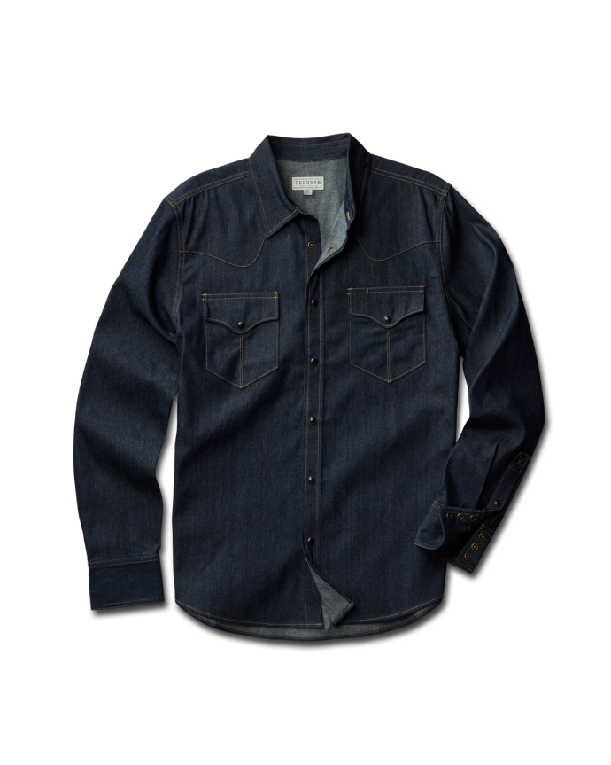 A long-sleeve, dark denim shirt with snap buttons, front yoke detailing, and two chest pockets, laid flat against a white background.
